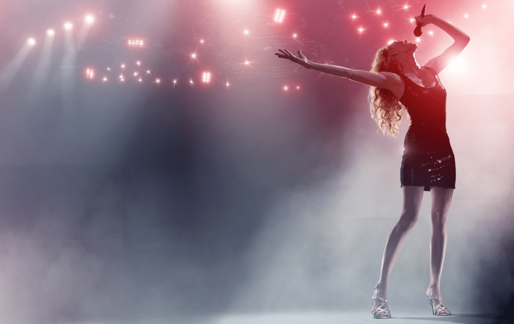 Performer using microphone on stage - Bax AV